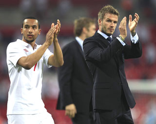 David Beckham (right) and England's Theo Walcott acknowledge the crowd after England's international friendly againt Mexico at Wembley Stadium on Monday