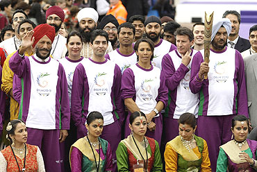 Chairman of the Selection Committee of the Athletics Federation of India, Gurbachan Singh Randhawa (right), is flanked by, (L-R) 1958 Commonwealth 400m gold medal winner Milka Singh, Indian national five times ladies squash champion Misha Soni, Olympic Gold medallist shooter Abhinav Bindra, hockey player Dilip Tirkey, British Olympian Kelly Holmes, English cricket player Monty Panesar and British Olympian Sebastian Coe during the CWG baton rally in London