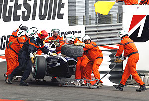 Track marshals remove the car of Williams Formula One driver Hulkenberg of Germany after he crashed out of the race during the Monaco F1 Grand Prix in Monte Carlo