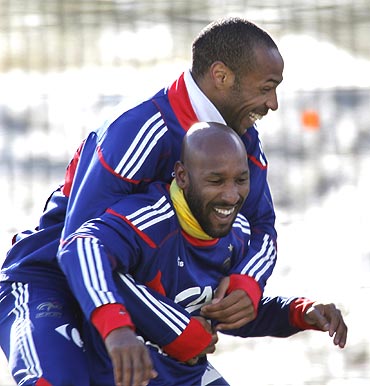France strikers Thierry Henry left and Nicolas Anelka share a light moment during a training session in Tignes