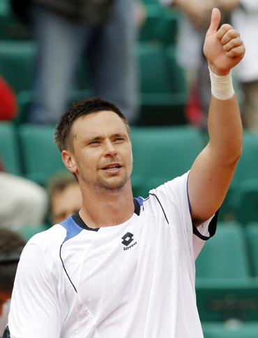 Soderling reacts after winning his match against Dent during the French Open