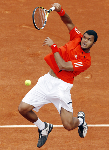 Tsonga of France returns the ball to his compatriot Ouanna