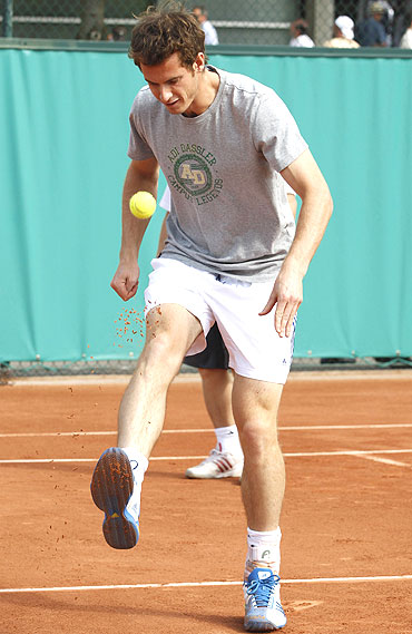 Murray plays football with a tennis ball during a training session in Paris