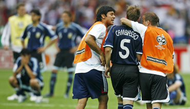 Argentina's Esteban Cambiasso is consoled by team mates after missing during the penalty shootout in the World Cup