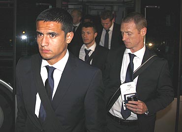 Tim Cahill (left) and his Australian team-mates arrive at Johannesburg airport