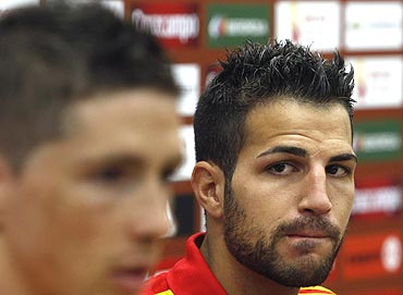 Spain's Cesc Fabregas (right) listens to team-mate Fernando Torres during a press conference