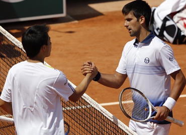Djokovic of Serbia shakes hands with Nishikori after winning