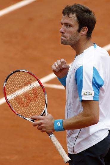 Teimuraz Gabashvili reacts after winning the match against Andy Roddick