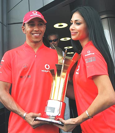 McLaren's Lewis Hamilton (left) and girlfriend Nicole Scherzinger with the trophy