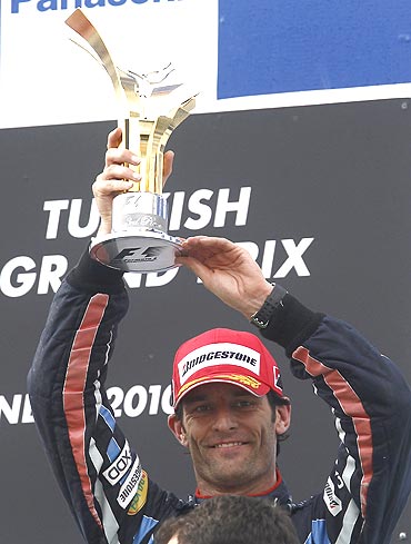 Red Bull's Mark Webber celebrates on the podium after a third place finish