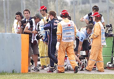 Red Bull's Sebastian Vettel (centre) walks after crashing out during the Turkish F1 Grand Prix