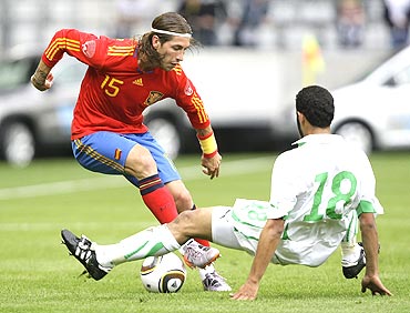 Spain's Sergio Ramos (left) and Saudi Arabia's Yasser Al Qahtani fight for possession during an international friendly in Innsbruck