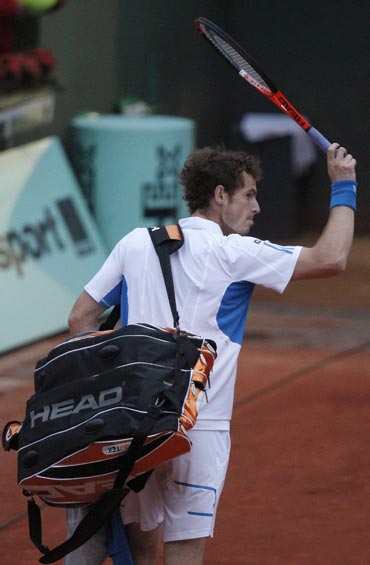 Andy Murray walks back after losing his match to Tomas Berdych