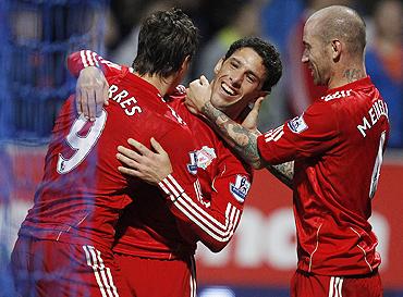 Liverpool's Maxi Rodriguez (centre) celebrates with Fernando Torres (left) and Raul Meireles (right) after scoring during against Bolton Wanderers on Sunday