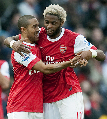 Arsenal's Alex Song (right) celebrates with teammate Gael Clichy after scoring against West Ham on Saturday