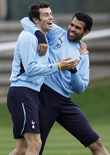 Tottenham Hotspur's Gareth Bale (left) wrestles with Sandro Ranieri during a training session in London on Monday