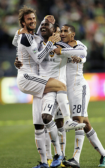 Los Angeles Galaxy midfielder David Beckham (left) celebrates with Edson Buddle (centre) after the latter scored in Game 1 of their MLS Western Conference semi-finals at Qwest Field in Seattle on Sunday