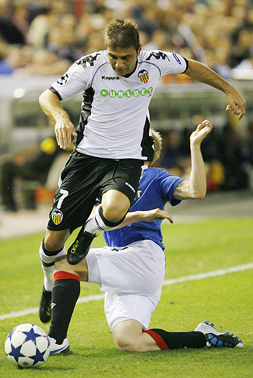 Valencia's Joaquin (foreground) is challenged by Rangers' Steven Naismith during their Champions League match on Tuesday
