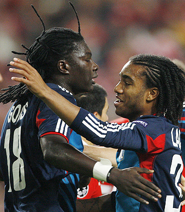 Olympique Lyon 's Bafetimbi Gomis (left) celebrates with teammate Alexandre Lacazette after scoring against Benfica on Tuesday