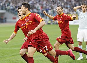 AS Roma's Marco Borriello (centre) celebrates with teammates Simone Perrotta (right) and Leandro Greco after scoring against Lazio on Sunday