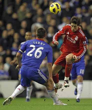 Fernando Torres heads the ball past John Terry
