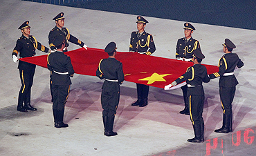 Soldiers hold the Chinese national flag during the opening ceremony