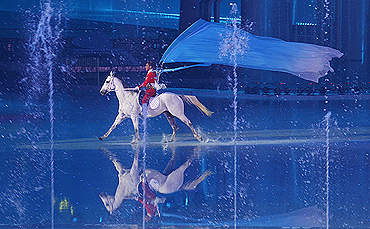 A performer is astride a horse during the opening ceremony