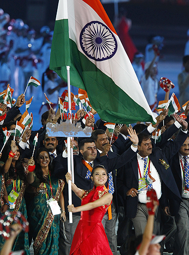 Gagan Narang leads out Indan athletes and officials during the opening ceremony