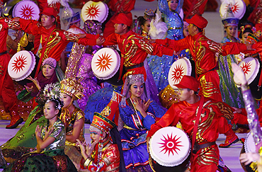 Performers dance to the beat of the drums during the opening ceremony