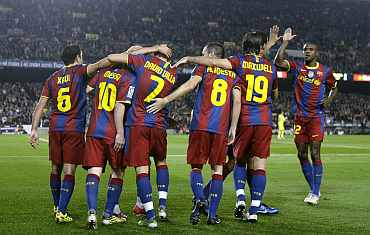 Barcelona players celebrate after scoring against Villarreal