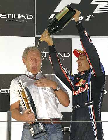 Sebastian Vettel celebrates with Red Bull Motorsport Director Helmut Marko after winning the Abu Dhabi F1 GP