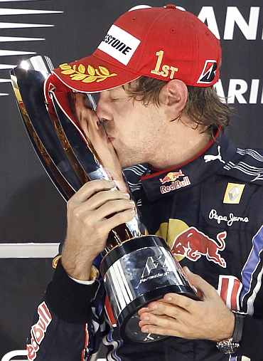 Red Bull driver Sebastian Vettel kisses the trophy after winning the Abu Dhabi F1 GP