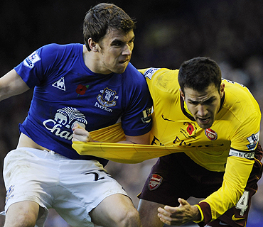 Everton's Coleman challenges Arsenal's Cesc Fabregas during their  match on Sunday