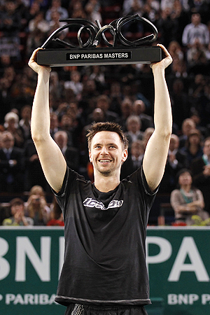 Sweden's Robin Soderling holds the winner's trophy after defeating France's Gael Monfils in the final of the Paris Masters on Sunday