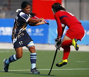 Japan's Manabe challenges India's Deepika during their pool hockey match at the 16th Asian Games on Tuesday