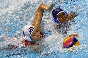 Uzbekistan's Anna Sheglova fights for the ball with India's Eekshitha Prasad during their women's water polo match