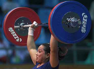 Monika Devi of India competes in the women's 69kg weightlifting competition