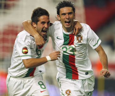Portugal's Helder Postiga (R) celebrates his goal with his teammate Joao Moutinho during an international soccer friendly match against Spain at Luz stadium in Lisbon