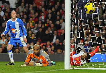 Manchester United's Patrice Evra scores against Wigan Athletic
