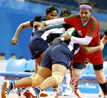 The Indian players tackle a Bangladesh player during the women's kabaddi group match game at the Asian Games