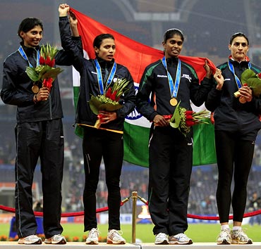 The Indian women 4x400m relay team with their gold medals at the 16th Asian Games