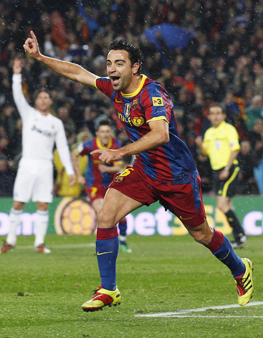 Barcelona's Xavi Hernandez celebrates after scoring the first goal against Real Madrid at Nou Camp on Monday