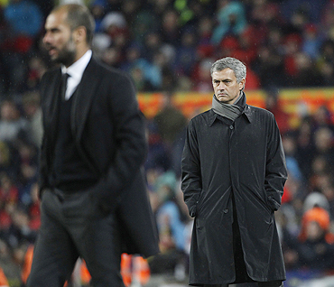 Jose Mourinho (right) and Pep Guardiola react during the 'El Clasico' on Monday