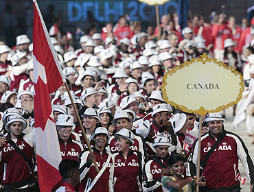 Flag bearer Ken Pereira of Canada leads his delegation into the Jawaharlal Nehru Stadium during the opening ceremony