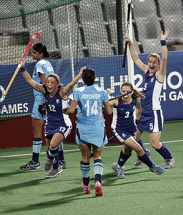 Scotland players celebrate after scoring the first goal against India during their hockey group match at the Commonwealth Games