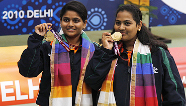 Anisa Sayyed of India (right) and compatriot Rahi Sarnobat pose with their gold medals after winning the women's 25m pairs pistol shooting competition