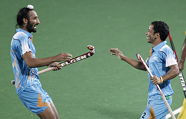 Bharat Chikkara (right) celebrates with Sardar Singh after scoring the winner against Malaysia