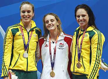 Fran Halsall of England along with Australia's silver medallist Marieke Guehrer (L) and bronze medallist Emily Seebohm (R)