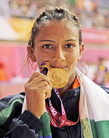 Gold medallist Geeta poses after winning the 55kg women's freestyle wrestling match on Thursday