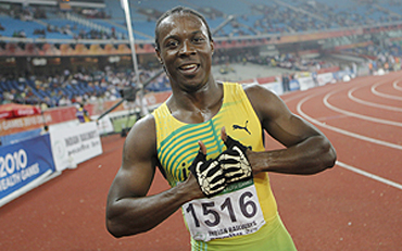 Jamaica's Lerone Ephraime Clarke celebrates after winning the men's 100 metre final on Thursday
